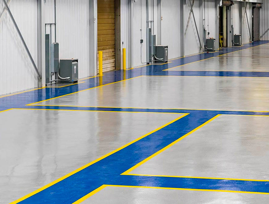 Industrial factory with branded color scheme for factory layout and walkways using colored epoxy flooring